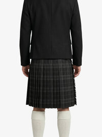 Person wearing a black jacket and plaid kilt on a white background