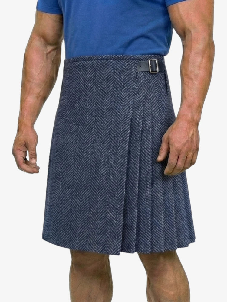 Person wearing a blue herringbone kilt on a white background