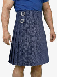 Person wearing a blue herringbone pattern kilt on a white background