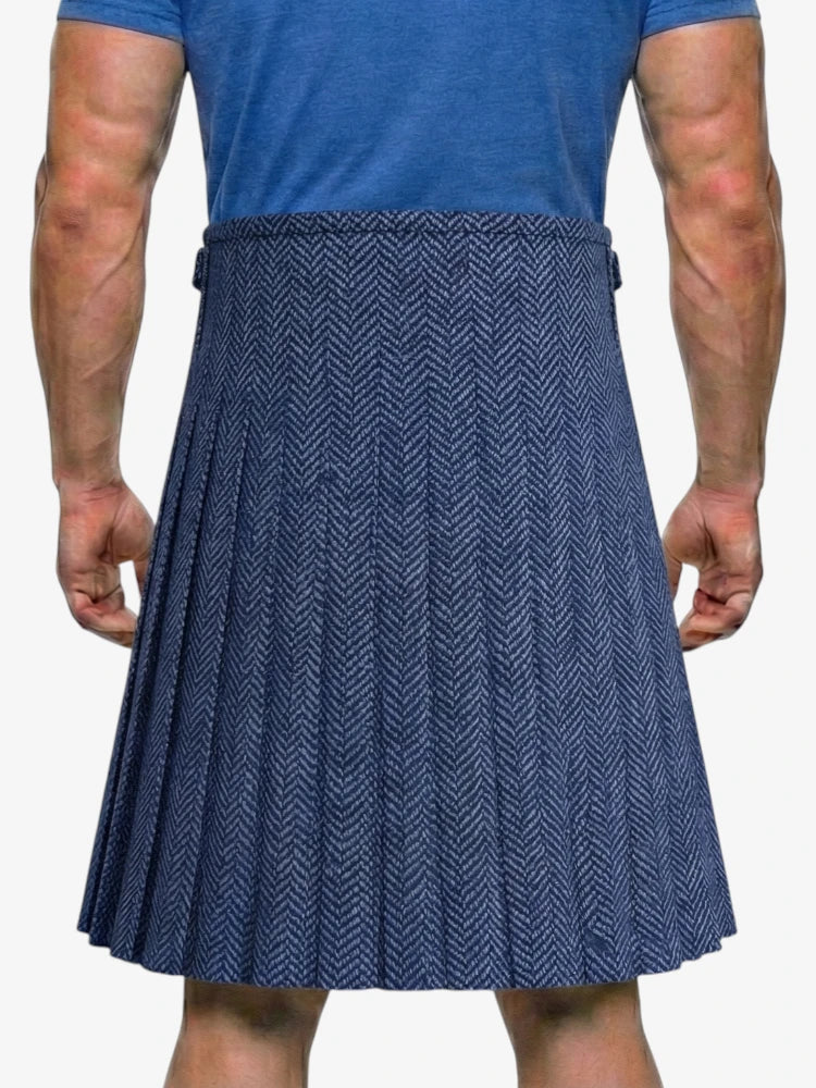 Person wearing a blue patterned kilt on a white background