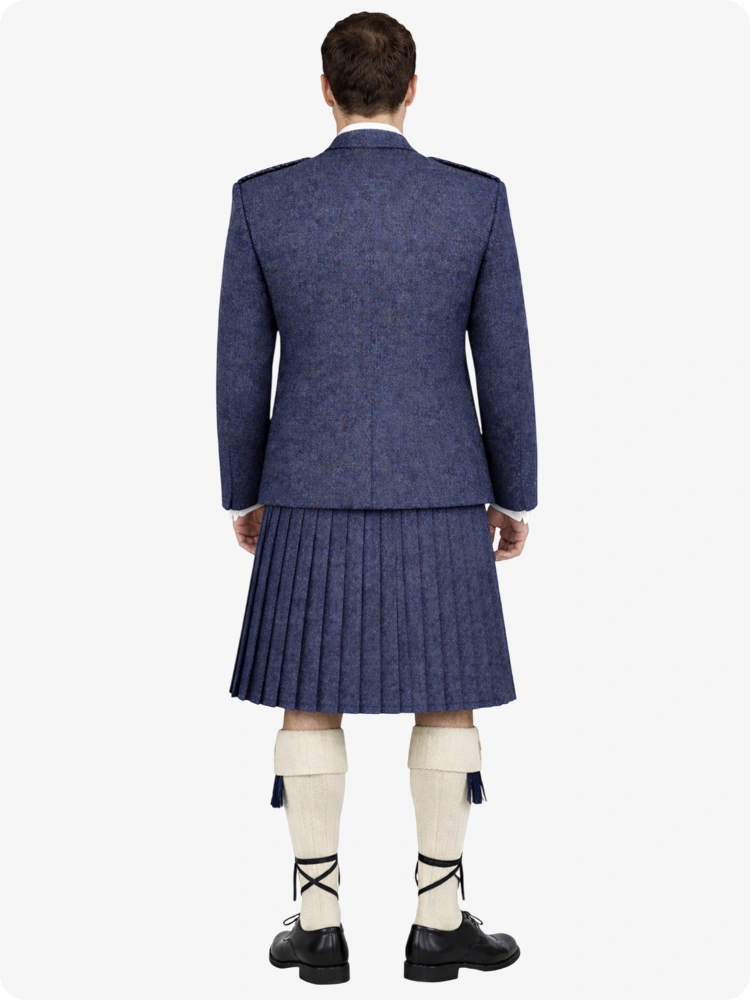 Person wearing a blue suit with a pleated kilt on a white background
