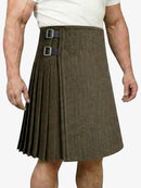 Brown pleated kilt worn by a person on a white background