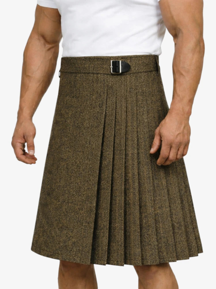 Brown pleated kilt worn by a person on a white background