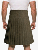 Person wearing a brown pleated kilt on a white background
