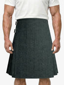 Person wearing a gray patterned kilt on a white background
