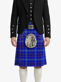 Person wearing a blue plaid kilt with a black jacket on a white background