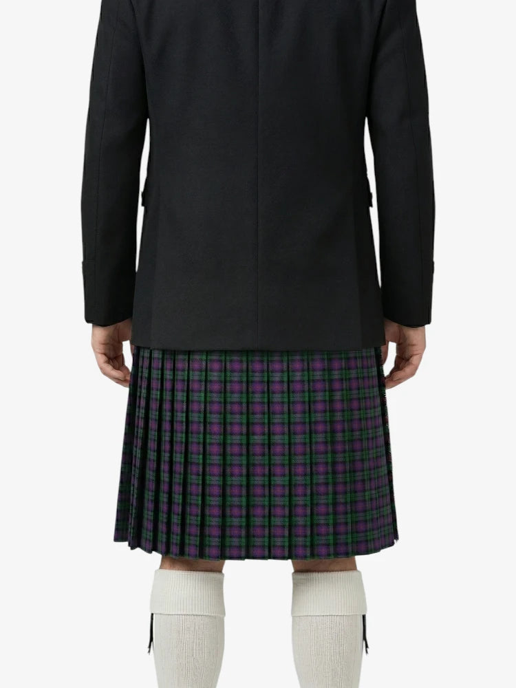 Person wearing a black coat and plaid kilt on a white background