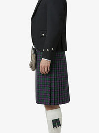 Person wearing a black jacket and plaid kilt on a white background