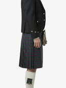 Person wearing a black jacket and plaid kilt on a white background