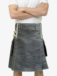 Person wearing a gray denim kilt with a white background