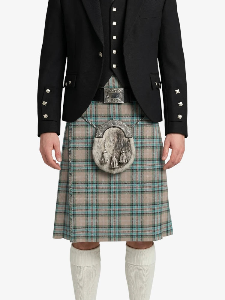 Person wearing a black jacket and plaid kilt on a white background
