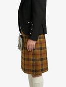 Person wearing a black blazer and plaid Kilt on a white background