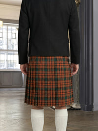 Person wearing a black jacket and red plaid kilt indoors.