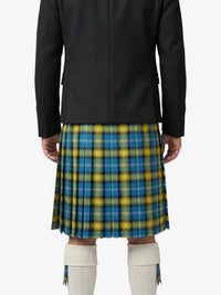 Person wearing a black coat over a blue and yellow plaid skirt on a white background