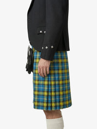 Person wearing a black jacket and blue and yellow plaid kilt on a white background