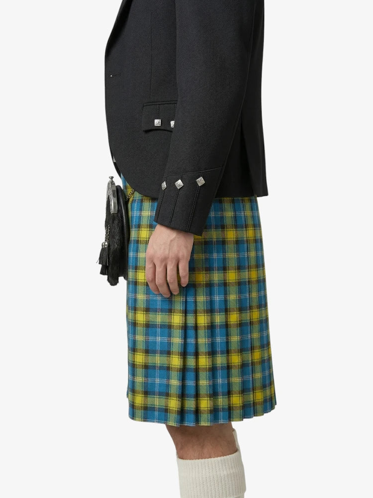 Person wearing a black jacket and blue and yellow plaid kilt on a white background