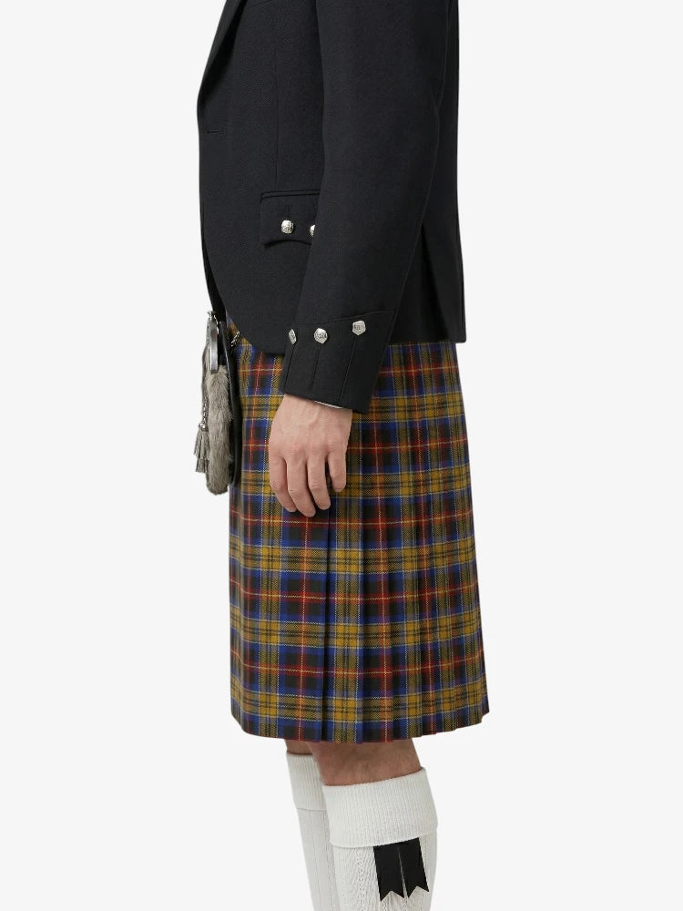 Person wearing a black jacket and plaid kilt on a white background