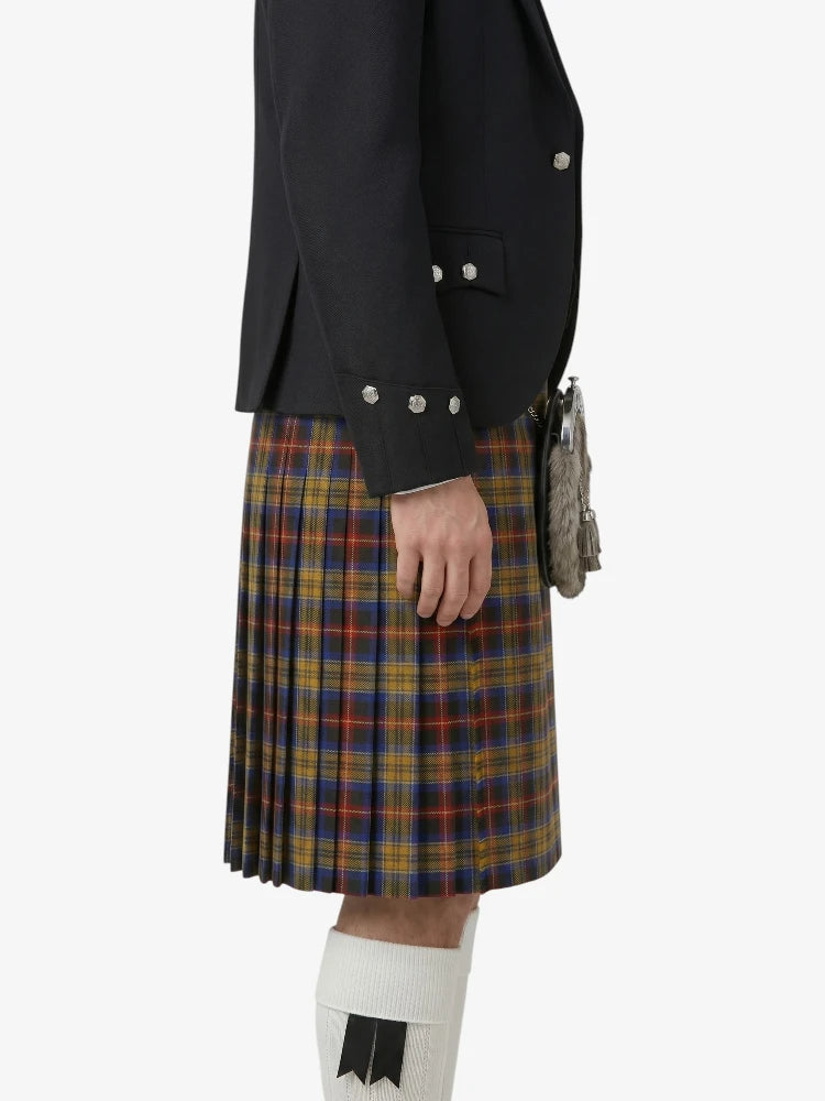 Person wearing a black jacket and plaid kilt on a white background