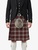 Person wearing a black jacket, vest, and red plaid kilt with a silver sporran on a white background
