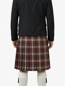 Person wearing a black jacket and plaid kilt on a white background