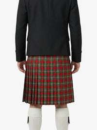 Person wearing a black jacket and red plaid kilt on a white background