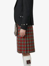 Person wearing a black jacket and red plaid kilt on a white background
