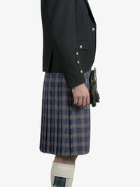 Person wearing a dark jacket and plaid kilt on a white background