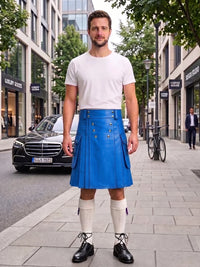 A man standing on a city sidewalk wearing a bright blue leather kilt, a white t-shirt, white knee-high socks, and black leather shoes. The background shows a street with buildings, a black Mercedes-Benz car, and a bicycle.