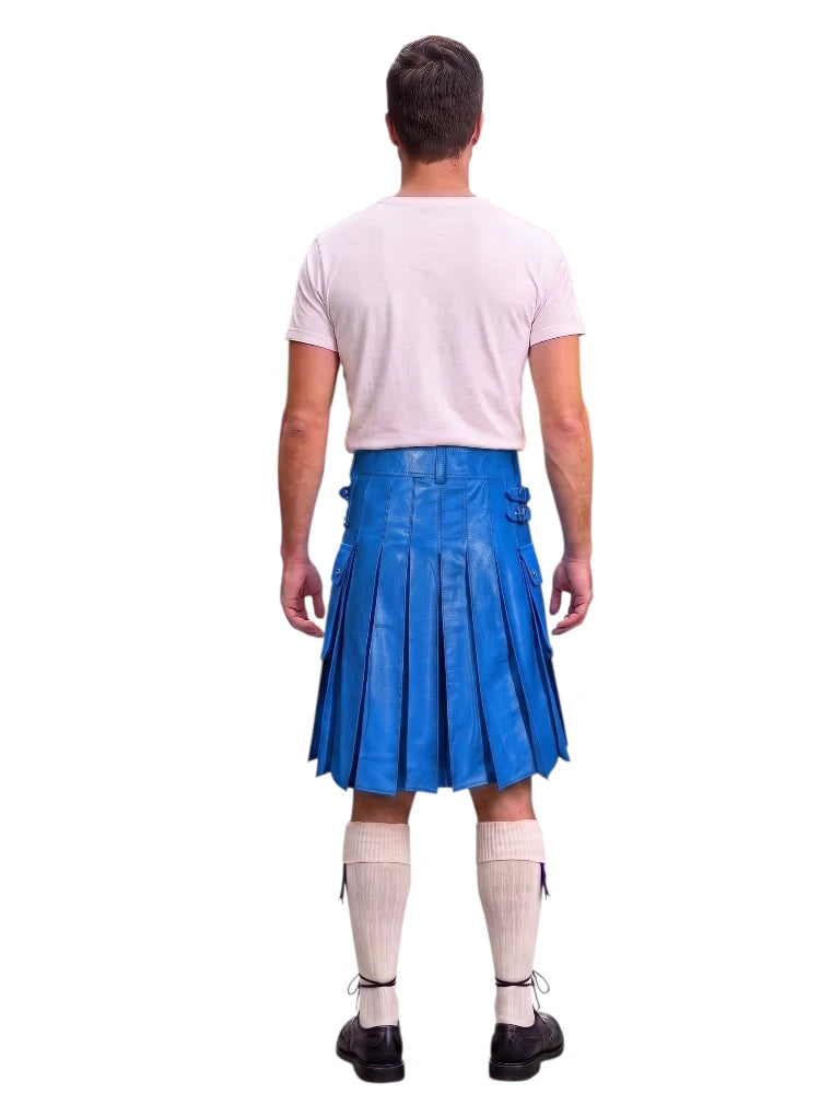 A man shown from the back wearing a bright blue pleated leather kilt, a light pink t-shirt, cream knee-high socks, and black shoes, isolated on a white background.