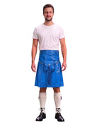 A man modeling a bright blue faux-leather kilt with a front pouch and tassel detail, styled with a white t-shirt, white knee-high socks, and black shoes against a plain white background.