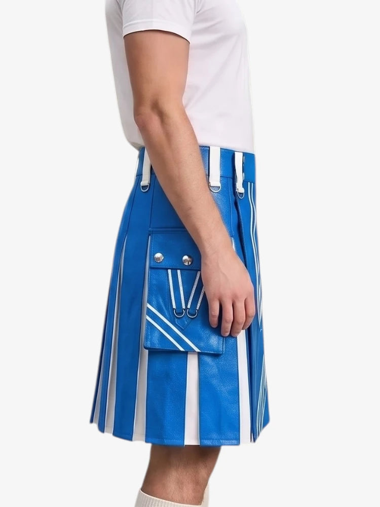 A person wearing a bright blue pleated kilt with bold white vertical stripes and a matching blue front flap pocket with silver-tone hardware, paired with a white t-shirt against a light gray studio background.