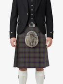 Person wearing a traditional Scottish kilt with a tartan pattern on a white background