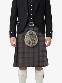 Person wearing a traditional Scottish kilt with a tartan pattern on a white background
