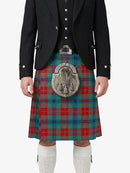 Person wearing a traditional Scottish kilt with a tartan pattern on a white background
