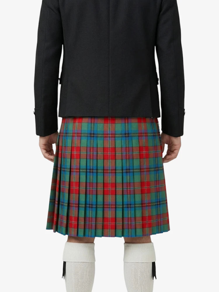 Person wearing a black jacket and a red, green, and blue plaid kilt on a white background