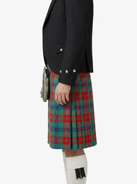 Person wearing a black jacket and red, green, and blue plaid kilt on a white background