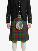 Person wearing a traditional Scottish kilt with a tartan pattern on a white background