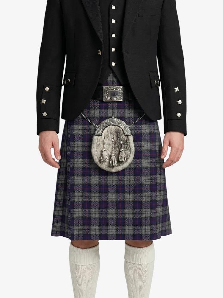 Person wearing a traditional Scottish kilt with a jacket and white knee-high socks on a white background