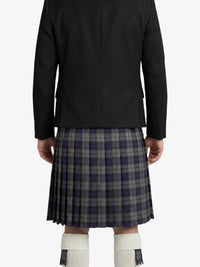 Person wearing a black jacket and plaid kilt on a white background