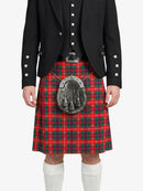 Person wearing a red tartan kilt with a black jacket on a white background