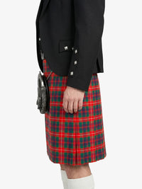 Person wearing a black blazer and red plaid kilt on a white background