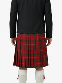 Person wearing a black jacket and red plaid kilt on a white background