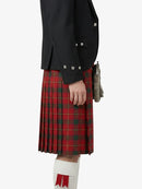 Person wearing a black jacket and red plaid kilt on a white background