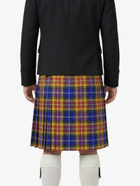 Person wearing a black jacket and colorful plaid kilt on a white background