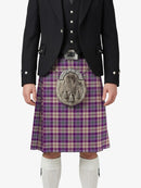 Person wearing a traditional Scottish kilt with a purple plaid pattern on a white background