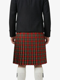 Person wearing a black jacket and red plaid kilt on a white background