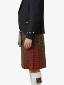Person wearing a black jacket and red plaid kilt on a white background