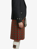 Person wearing a black jacket and red plaid kilt on a white background