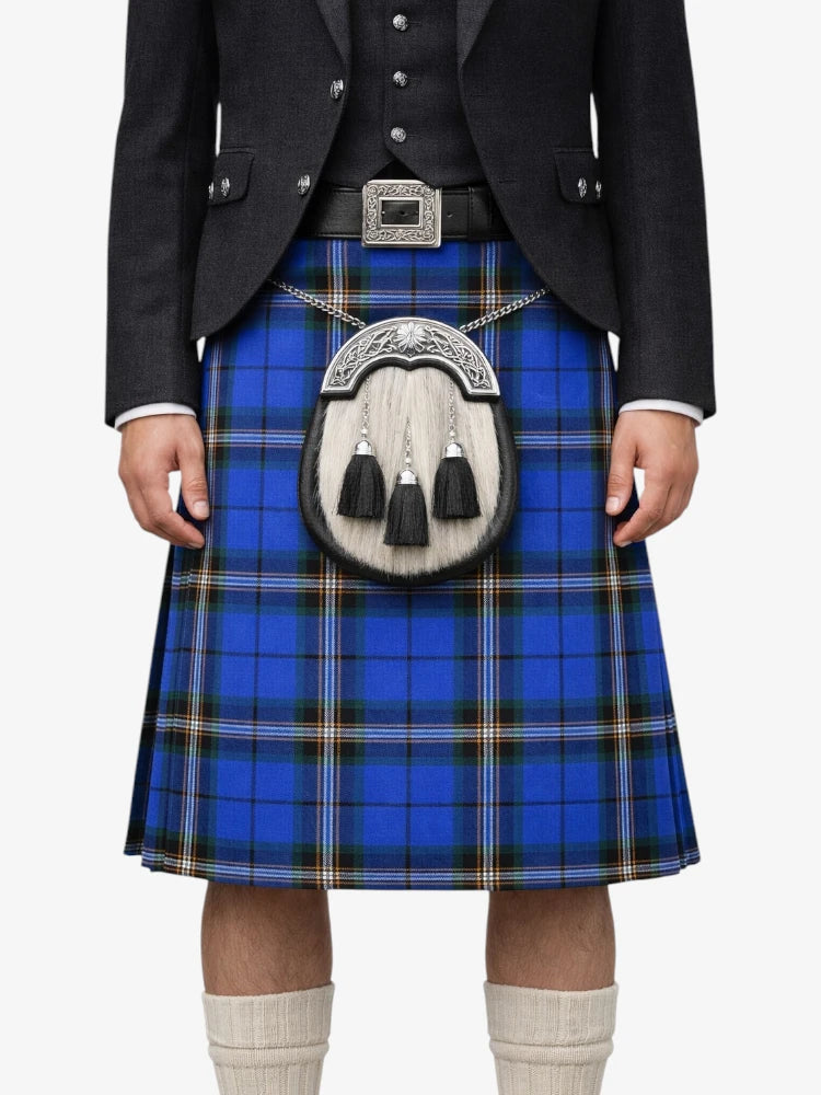 Person wearing a blue plaid kilt with a black jacket and white shirt on a white background