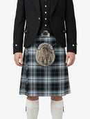 Person wearing a traditional Scottish kilt with a jacket on a white background
